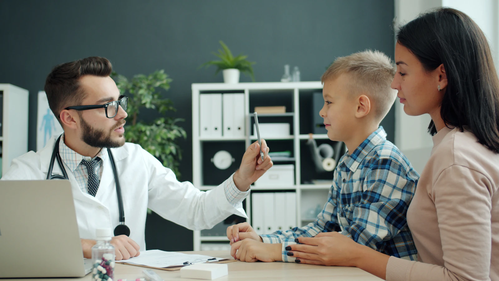 A child and parent meeting with a family doctor