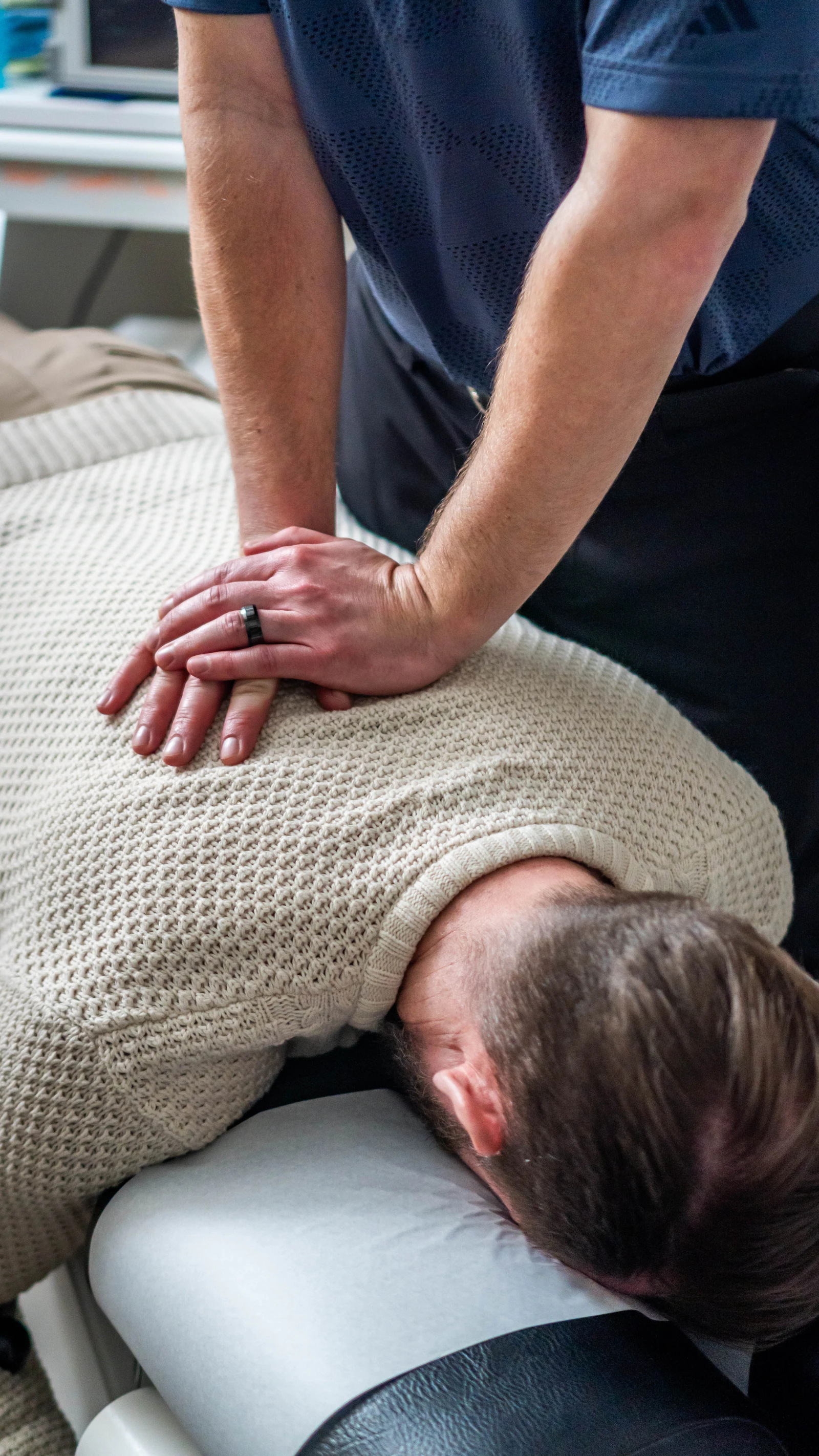 Chiropractor performing a hands-on spinal adjustment