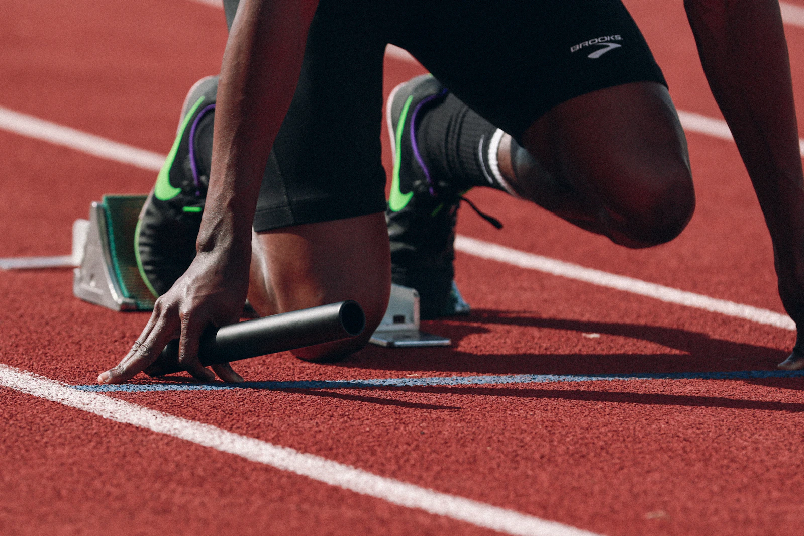 Young athlete sprinting from the starting blocks